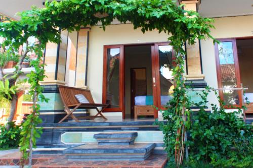 an entrance to a house with an arch and stairs at CR Tris Rooms Seminyak in Seminyak