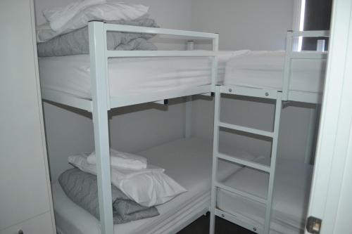 a white bunk room with white bunk beds at Yarrawonga Holiday Park in Yarrawonga