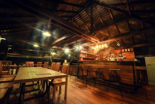
a kitchen with a wooden table and wooden chairs at Panvaree The Greenery in Ban Chieo Ko
