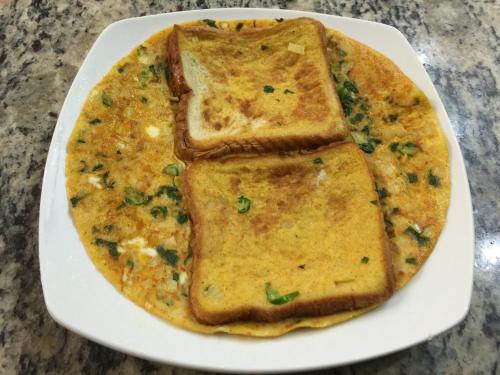 a white plate with two slices of omelet at Aqua De Vida in Bhowāli