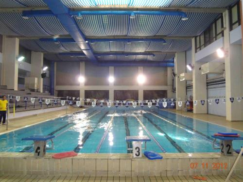 a large indoor swimming pool with people in it at Puntaquattroventi in Ercolano