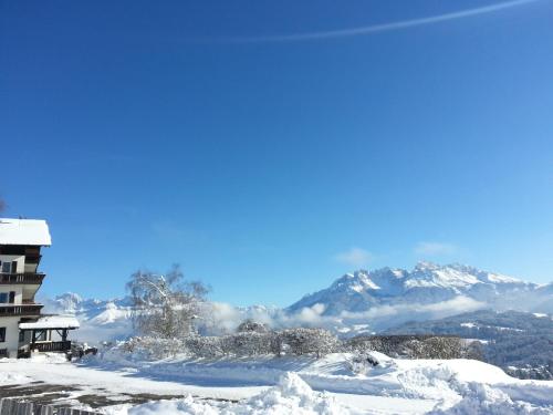 a snow covered mountain with mountains in the background at Panoramahotel Obkircher in Nova Ponente