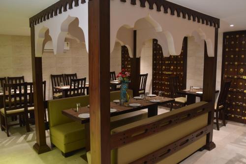 a restaurant with a table and chairs in a room at Jaipur Hotel New - Heritage Hotel in Jaipur