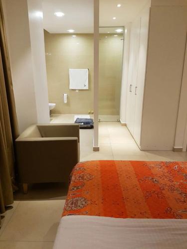 a bathroom with a sink and a tub in a room at Suncity Hotel Apartment in Accra