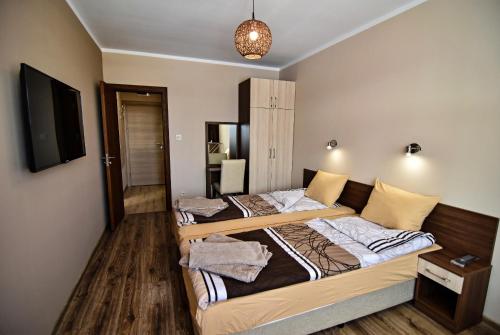 מיטה או מיטות בחדר ב-Zarevata Guest House