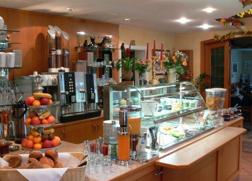 a restaurant with a buffet of food on a counter at Hotel Quellenhof in Bad Breisig