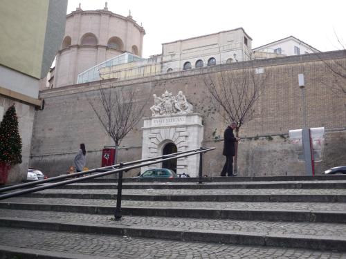 a man standing on stairs in front of a building at My Bed Vatican Museum in Rome