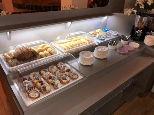 a display case filled with lots of different types of donuts at K-Triumf Resort in Velichovky