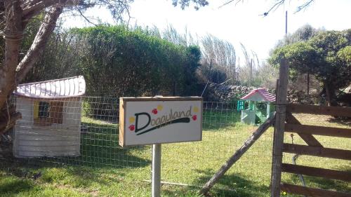 a sign in front of a fence in a yard at L'Araucaria turismo rurale in Santa Croce Camerina