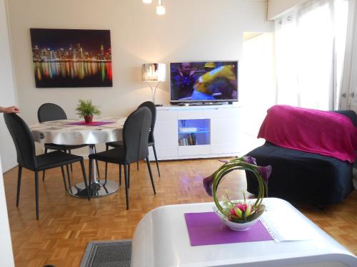 ein Wohnzimmer mit Tisch und Couch in der Unterkunft Gîte Bretagne in Rouen