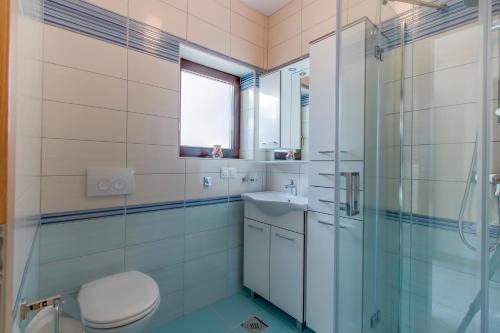a bathroom with a toilet and a sink and a shower at Apartment Simona in Mali Lošinj