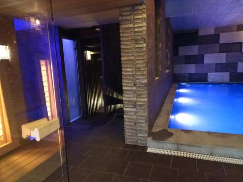 a swimming pool in the middle of a building at Penzion Zlaty Orol in Helcmanovce