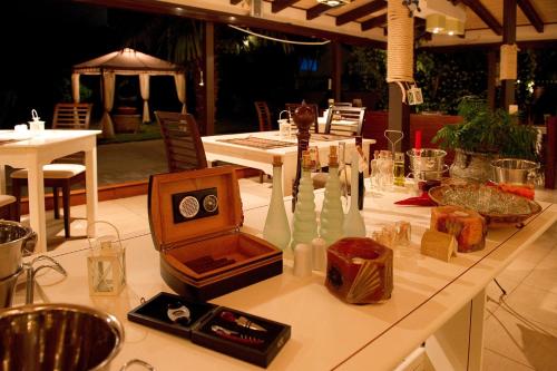 a white table with a clock on top of it at Alfa Hotel in Parga