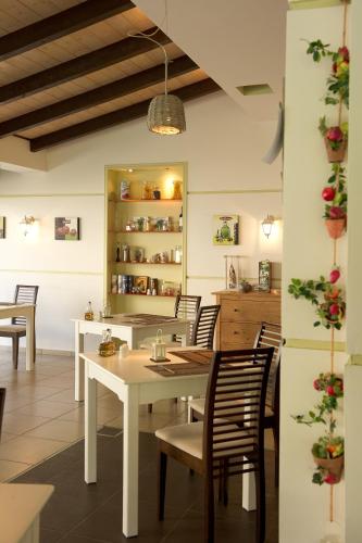 a dining room with a white table and chairs at Alfa Hotel in Parga