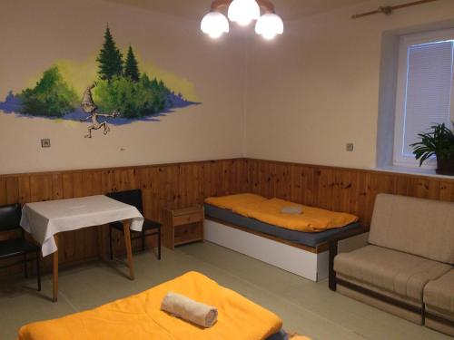 a room with two beds and a couch at Chata Orlí vrch in Zlaté Hory
