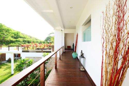 a balcony with a view of a garden at Villa Nambung in Selong Belanak