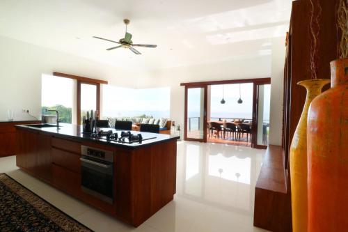 a kitchen with a stove and a counter top at Villa Nambung in Selong Belanak