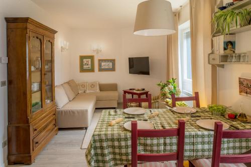 a living room with a table and a couch at Casa Nia in Madonna di Campiglio