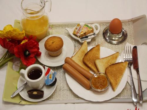 a table topped with plates of food and a cup of coffee at Best Season Apart Hotel in Kyiv