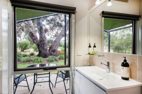 a bathroom with a sink and a window at Southern Grampians Cottages in Dunkeld