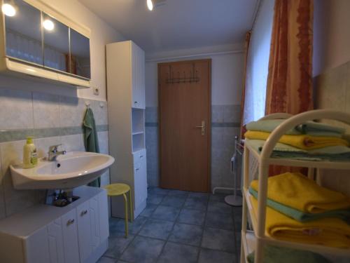 a bathroom with a sink and a bathroom with a bunk bed at Lovely Apartment near Sea in Klutz in Klütz