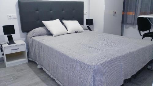 アリカンテにあるTemporary Alicante TMのベッドルーム1室(大型ベッド1台、枕2つ付)