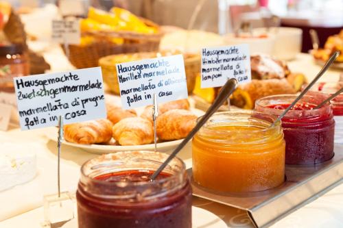a display of jam and other food items on a table at Hotel Tyrol in Funes