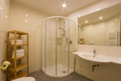 a bathroom with a shower and a sink at Residence Emmy in San Candido