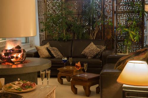 a living room with a couch and a fire place at Il San Francesco Charming Hotel in Sabaudia