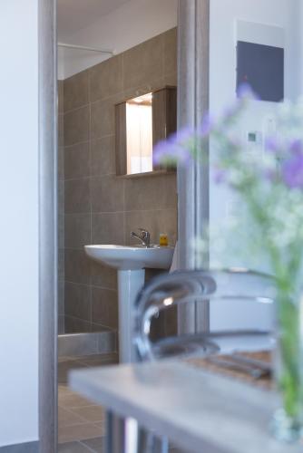 a bathroom with a sink and a mirror and a sink at House Okto in Alexandroupoli