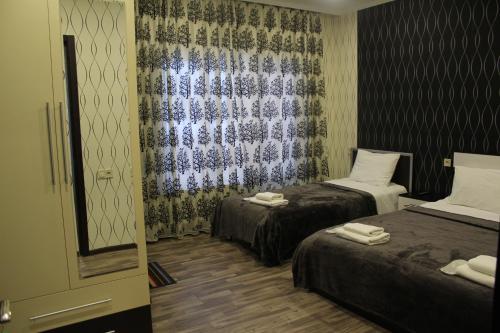 a hotel room with two beds and a window at ''Aragvi'' hotel in Naghorevi