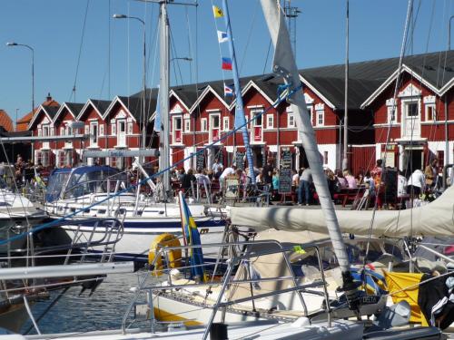 a group of boats docked in a harbor with houses at Skagen hytte in Skagen