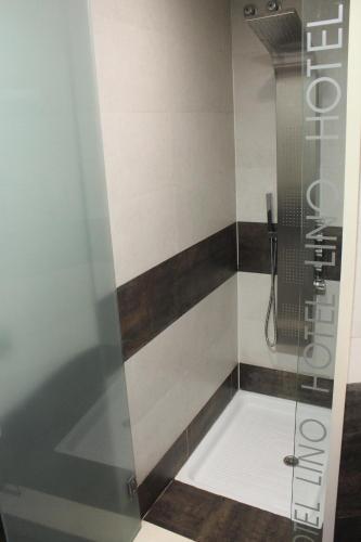 a shower with a glass door in a bathroom at Hotel Lino in Vigo