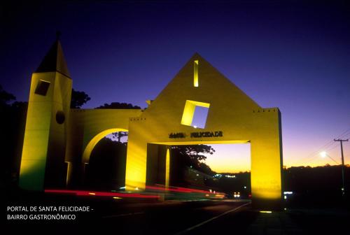a large building with a tower and a church at Lira Hotel in Curitiba