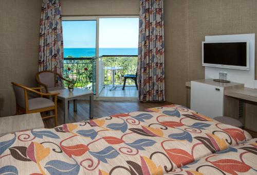 a bedroom with a bed and a view of the ocean at Riviera Hotel & Spa in Alanya