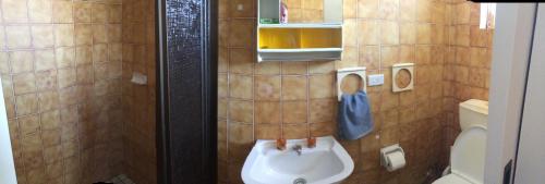 a bathroom with a toilet and a sink at Aquarius Holiday Apartments in Batemans Bay