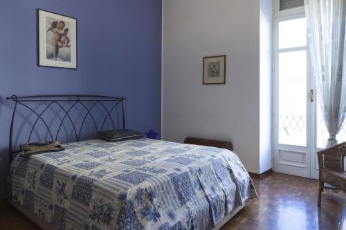 a bedroom with a bed with a blue wall at Dimora del Bonsignore in Turin