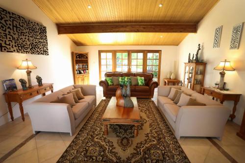 a living room with two couches and a coffee table at Nivalis Bed And Breakfast in Henley Brook