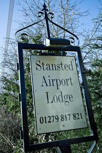 a sign for a stranded airport lodge on a street at Stansted Airport Lodge in Takeley