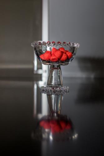 a glass bowl filled with red strawberries on a table at Gite "le millésime" in Épernay