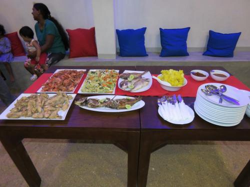 a table with many different types of food on it at Paradise Bay in Beruwala