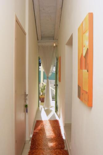 a hallway with an orange rug on the floor at Glavounos House in Ágios Matthaíos