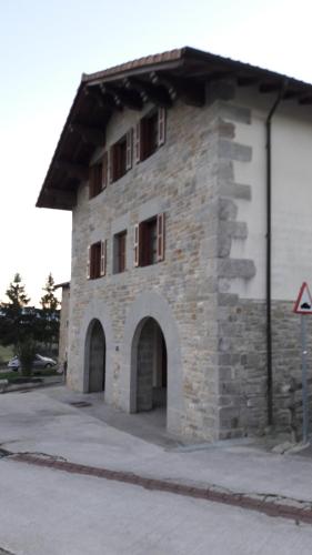 a large stone building with an arched doorway at Cortea I y II in Añézcar