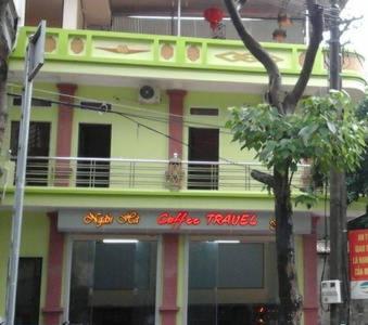 a yellow and pink building with a balcony at Ngan Ha Homestay in Ha Giang