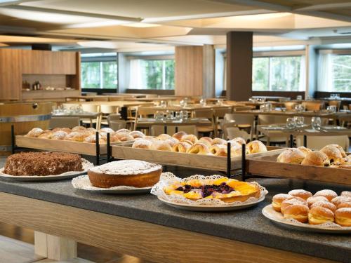 a bakery with many different types of pastries on a counter at TH Marilleva in Mezzana