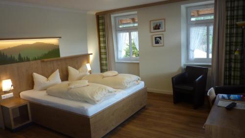 a bedroom with a bed with two pillows on it at Gasthaus Sonne Neuhäusle in Sankt Märgen