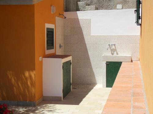 a small bathroom with a sink and a sink at La Casa Di Ninetta in Rio Marina