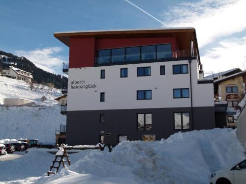 a building in the snow with snow around it at Alberts Heimatglück in Nauders