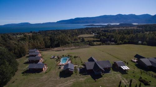 an aerial view of a farm with a group of huts at Cabañas Copayapu in Pucón