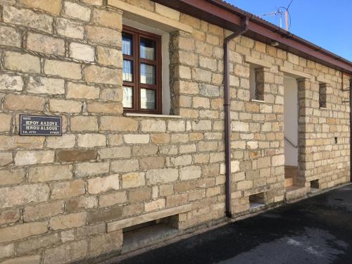 a brick building with a window and a sign on it at Arsos Village Apartment in Arsos